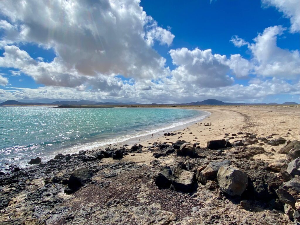 leerer Strand mit Steinhaufen am Rand